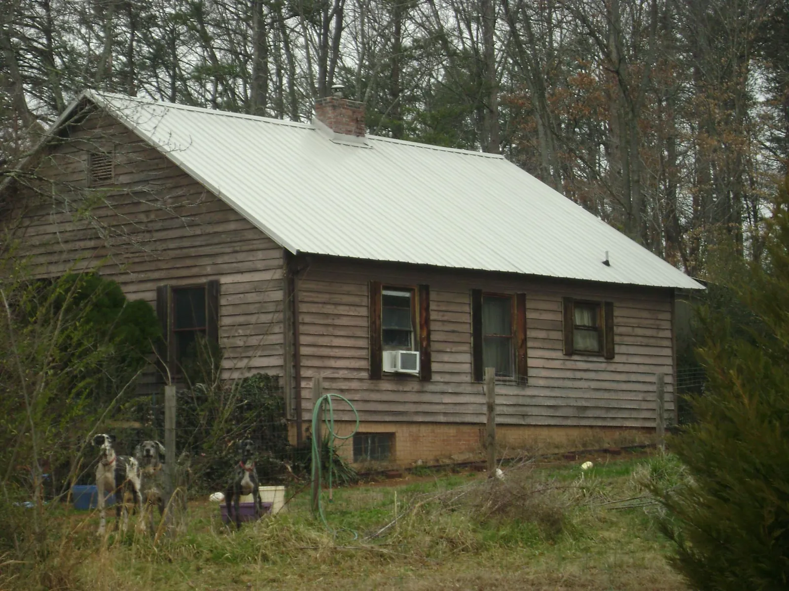 White metal roof on an old wood sided farmhouse, from a Metal Roof Installation job in Lucama